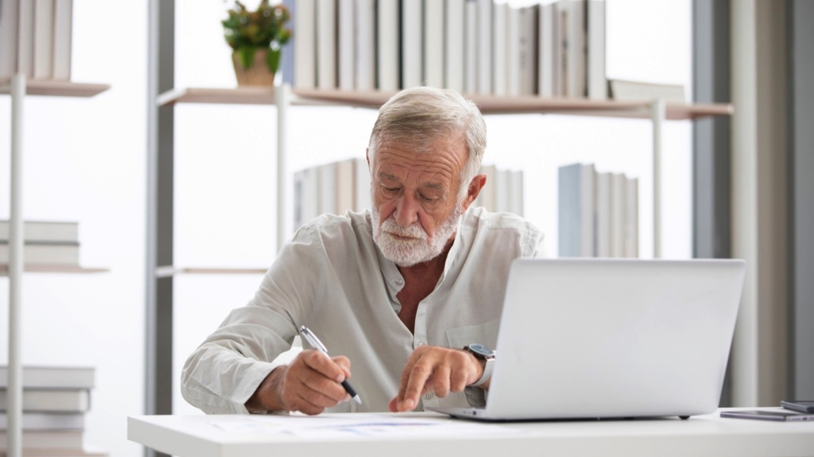 Old man writing check