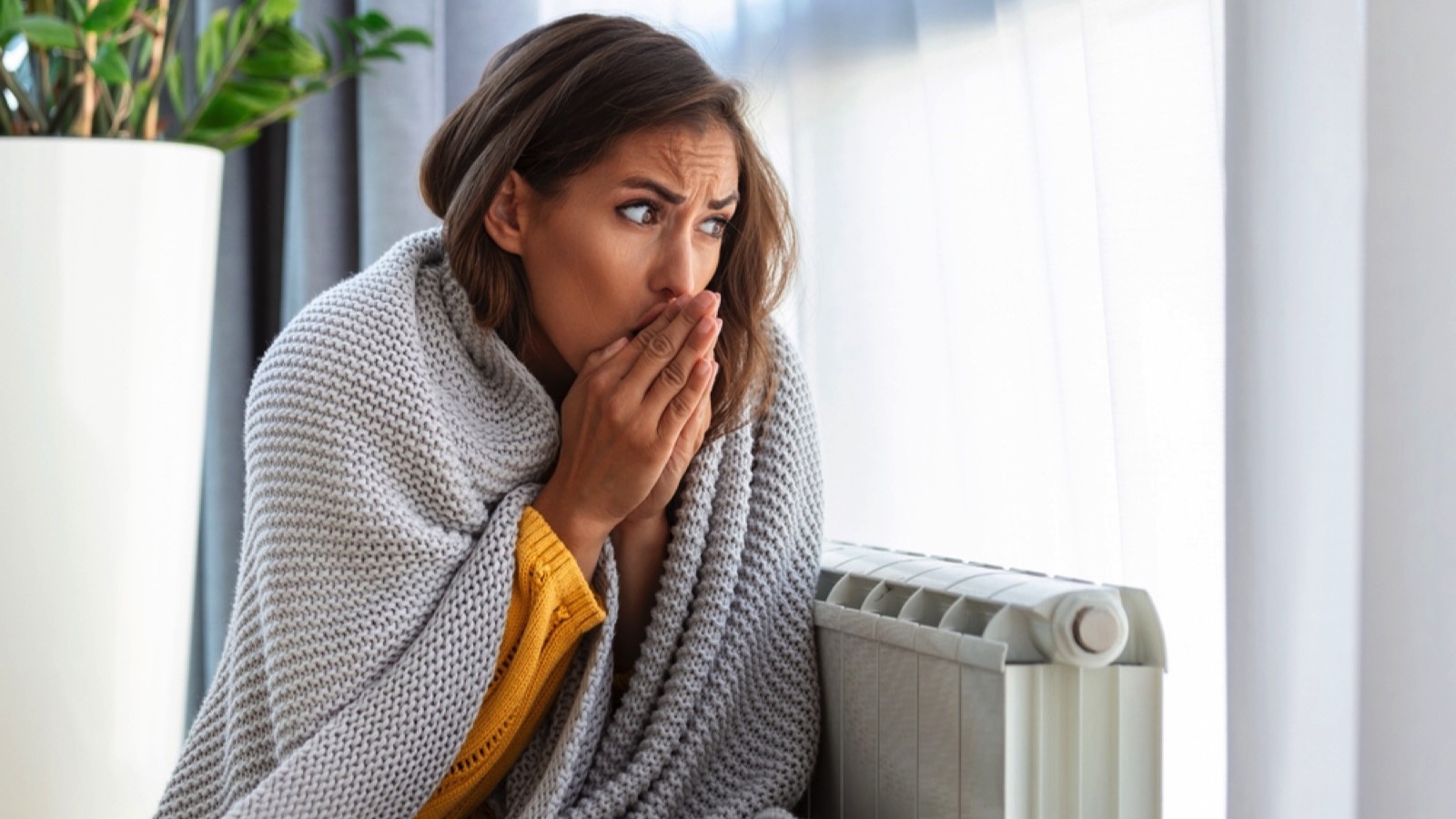 Woman feeling cold rubbing hands