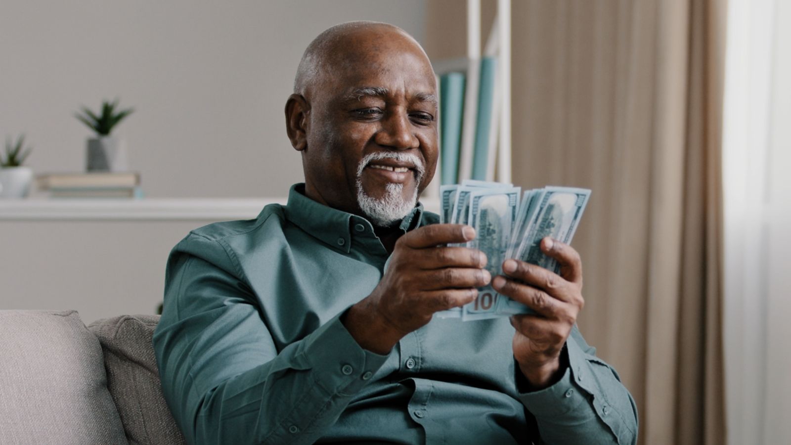 old man money smiling MAYA LAB Shutterstock